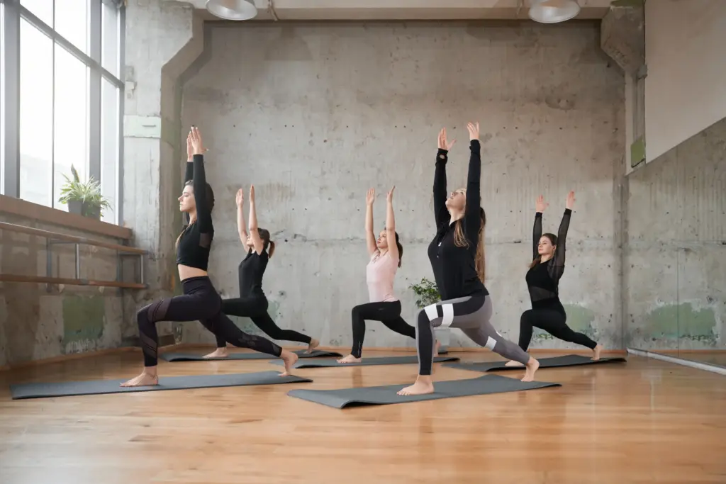 Students stretching together on yoga mats