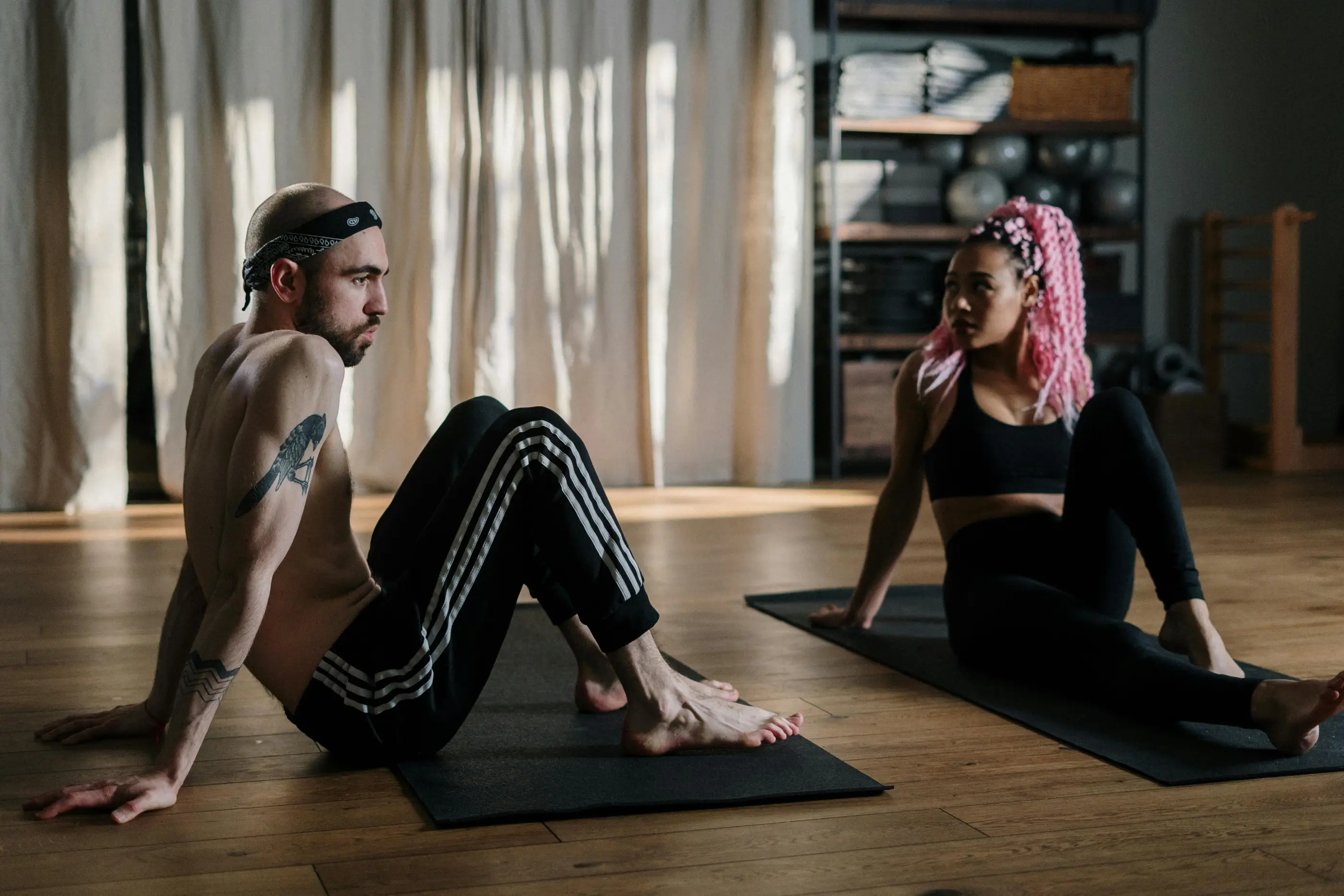 Two students stretching together in a studio